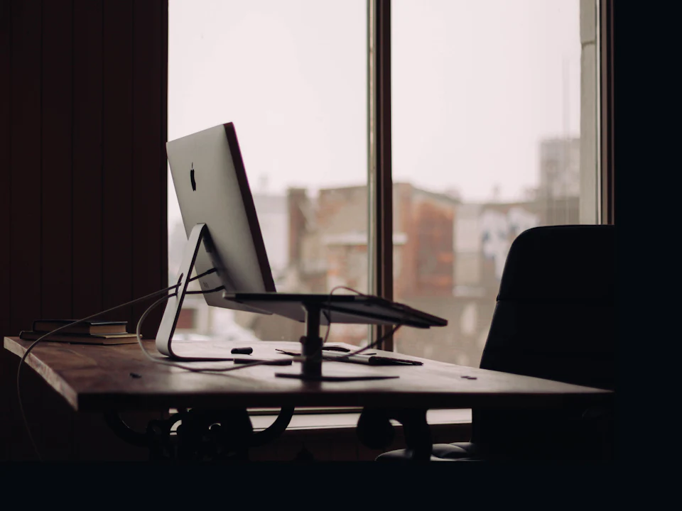 Executive desk with a monitor beside a city view