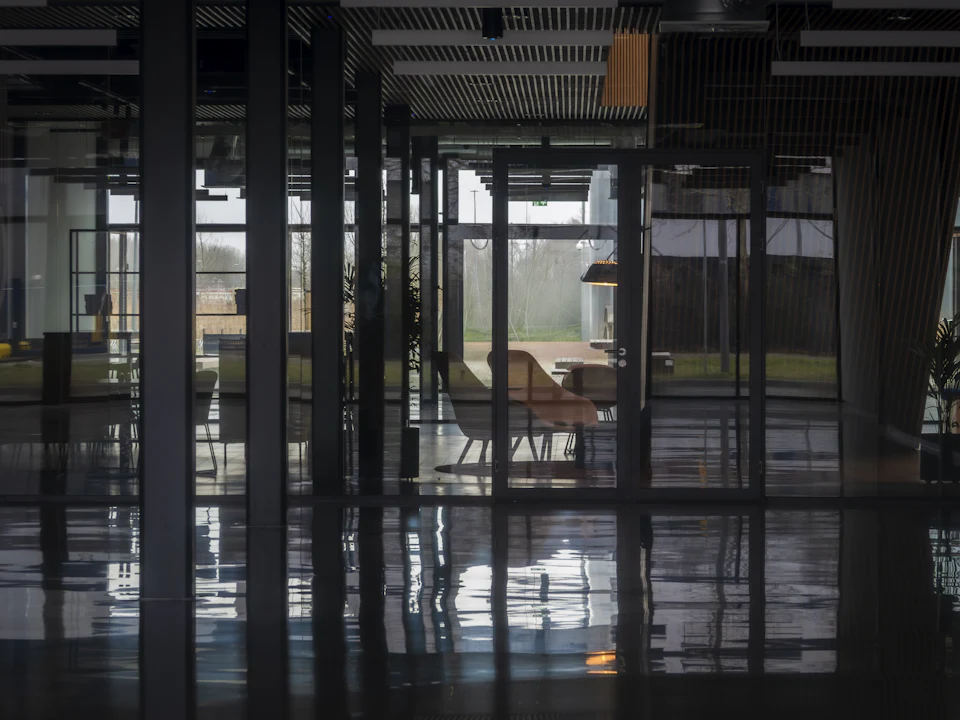 Glass entrance of a corporate building at night
